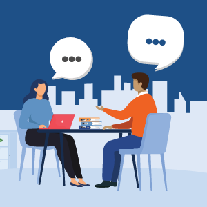 Two illustrated characters sit at a table. A laptop and books are on the table and buildings are shown in the background. Speech "bubbles" are shown above the characters and their words are indicated by three dots. Meant to show an interview situation in an office.